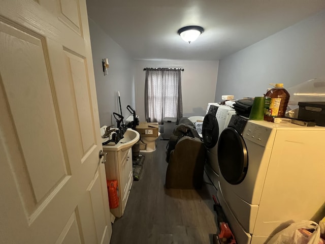 washroom with dark hardwood / wood-style flooring and washing machine and clothes dryer