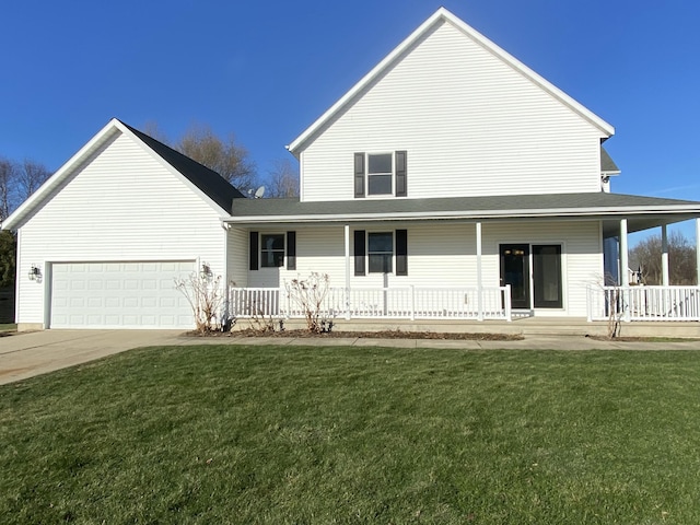 rear view of property with a garage, covered porch, and a lawn