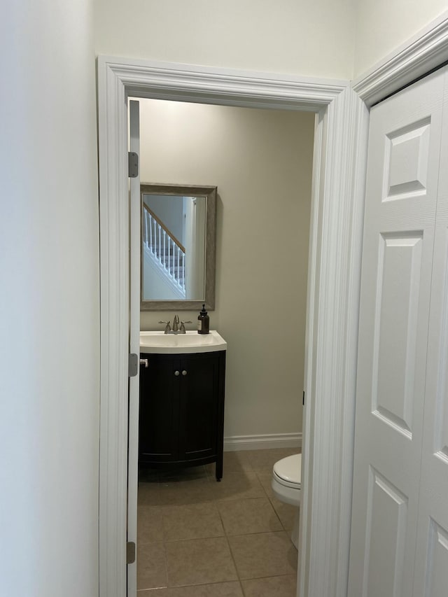 bathroom with tile patterned floors, toilet, and vanity