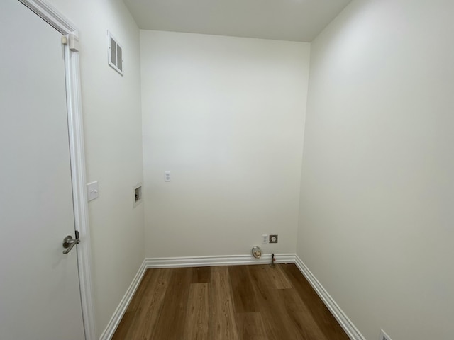 clothes washing area featuring hookup for a washing machine, hardwood / wood-style floors, and electric dryer hookup