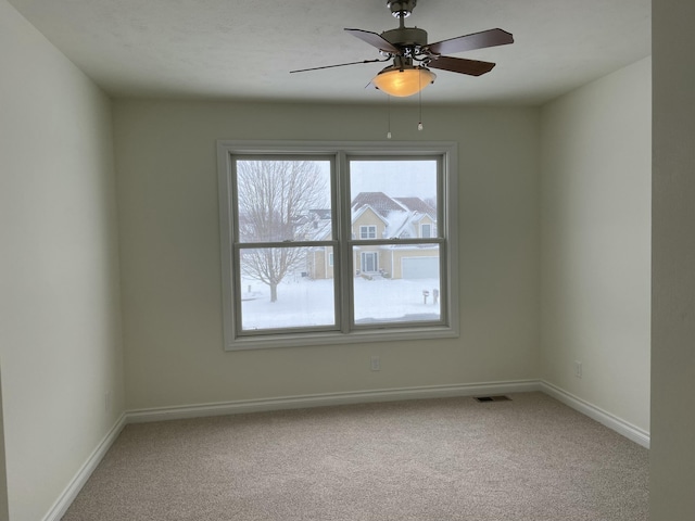 empty room with ceiling fan and carpet flooring