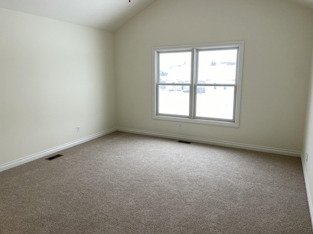 unfurnished room with lofted ceiling and carpet