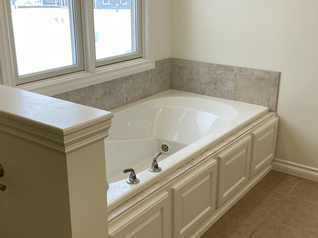 bathroom featuring tile patterned floors and a tub