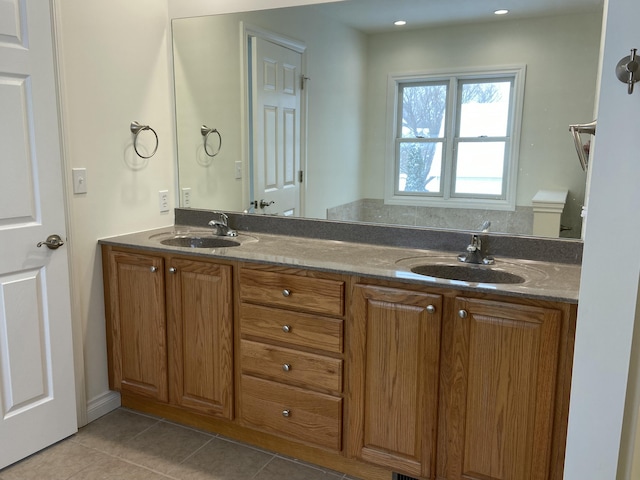 bathroom featuring tile patterned flooring, vanity, and toilet