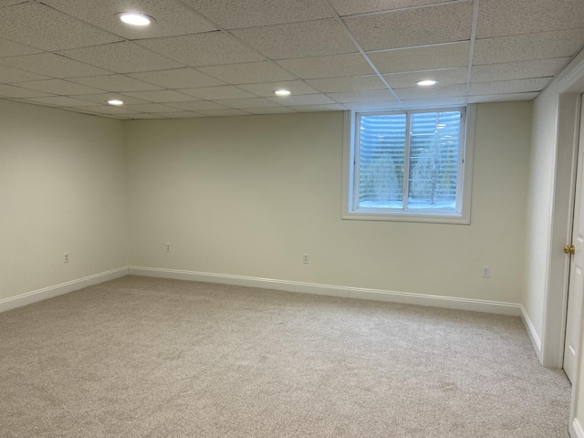 unfurnished room featuring carpet flooring and a paneled ceiling