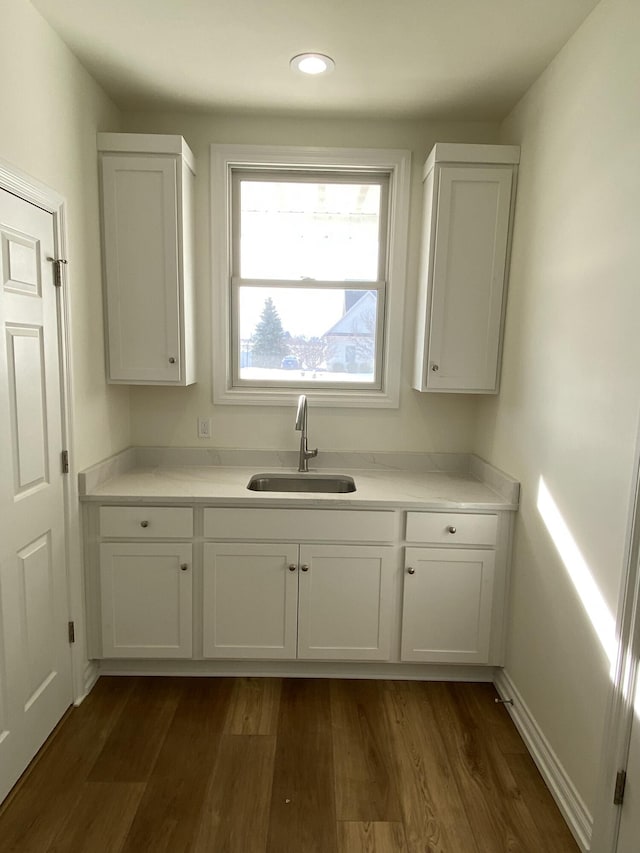 kitchen featuring sink, dark hardwood / wood-style floors, and white cabinets