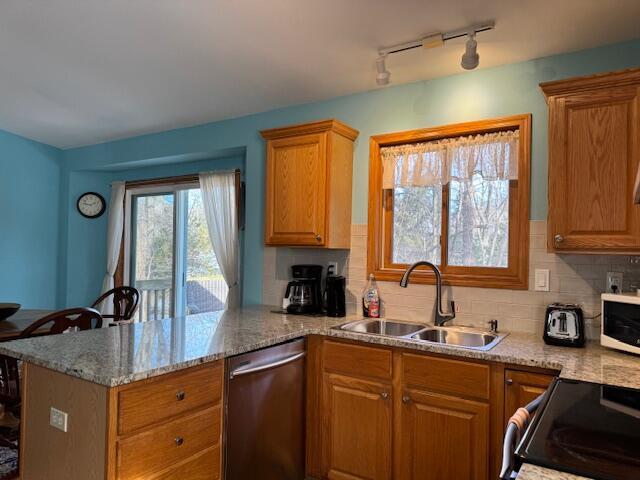 kitchen featuring sink, electric range, stainless steel dishwasher, and kitchen peninsula