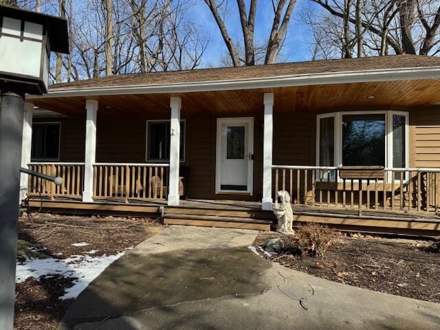 view of exterior entry with a porch