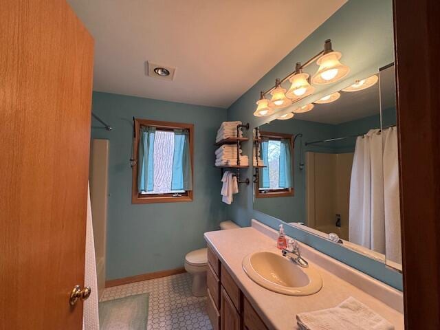 full bathroom with vanity, a wealth of natural light, shower / bath combo, and toilet