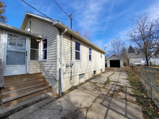 view of property exterior with a garage and an outdoor structure