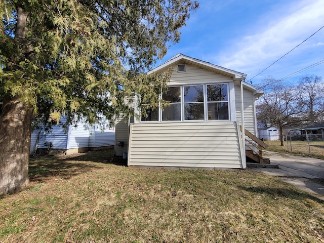 view of side of property with a lawn