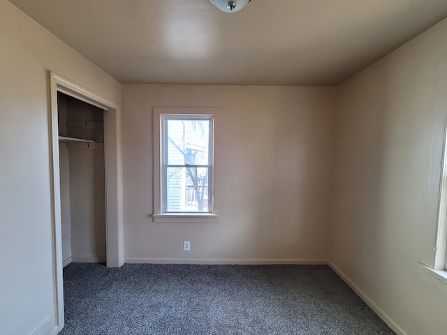 unfurnished bedroom featuring carpet floors and a closet