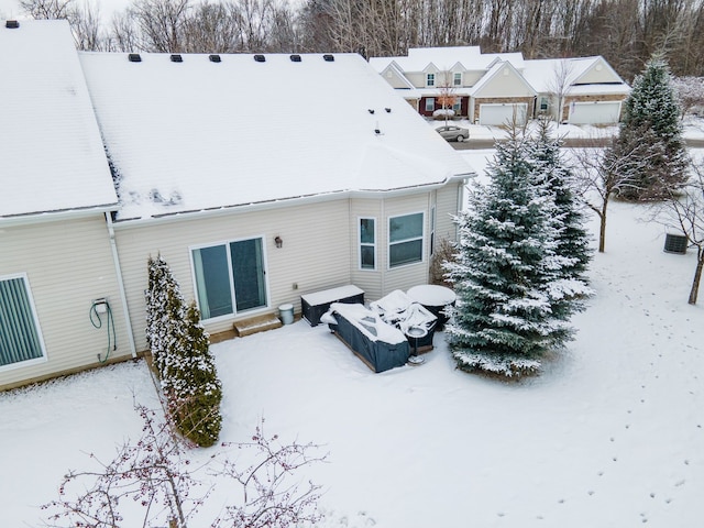 view of snow covered back of property