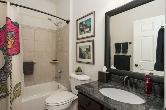 full bathroom with vanity, toilet, and shower / tub combo with curtain