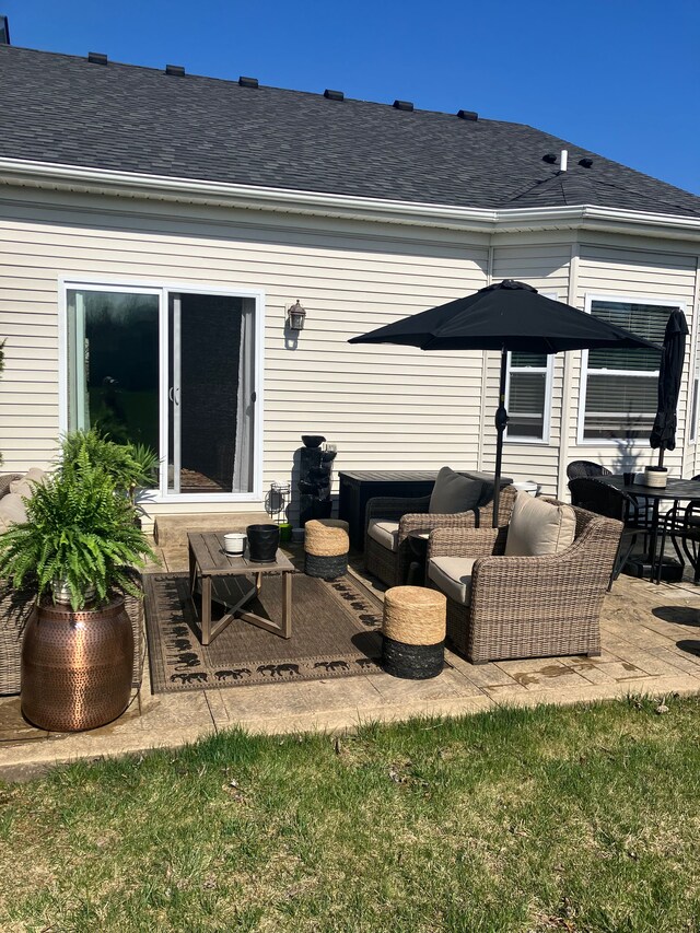 back of property with an outdoor hangout area and a patio