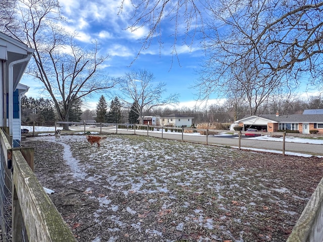 view of yard layered in snow