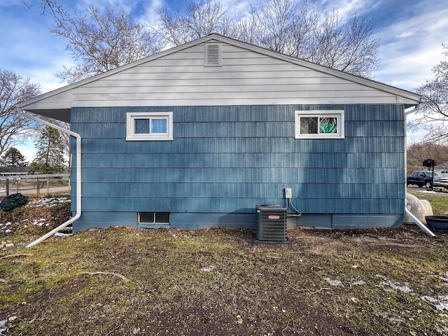 view of side of home featuring central AC