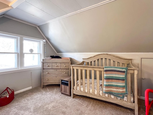 bedroom with carpet flooring, vaulted ceiling, and a nursery area