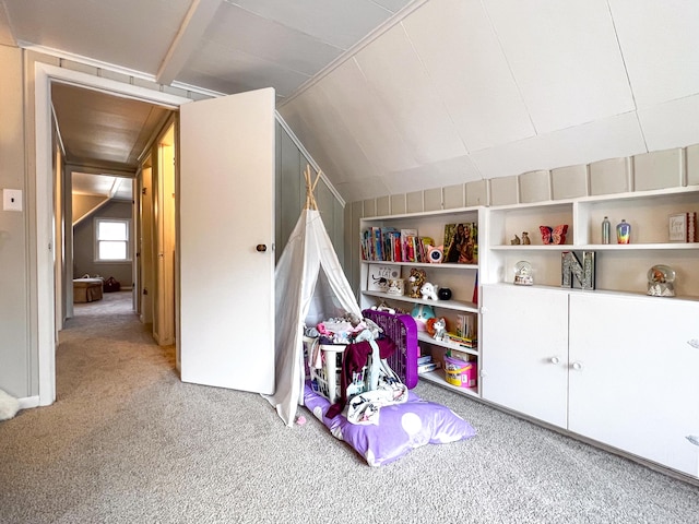 recreation room featuring carpet, lofted ceiling, and built in shelves