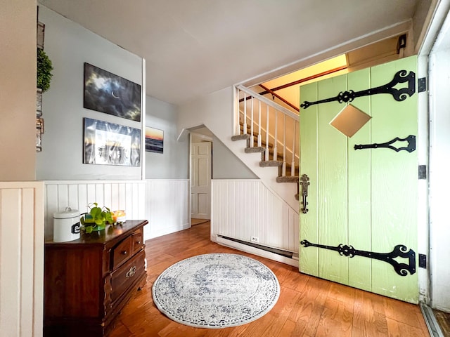 entryway featuring wood-type flooring and a baseboard radiator