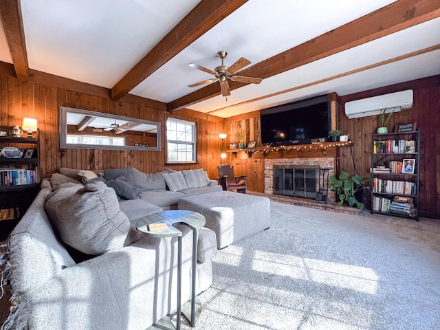 carpeted living room featuring a brick fireplace, wood walls, a wall unit AC, ceiling fan, and beam ceiling