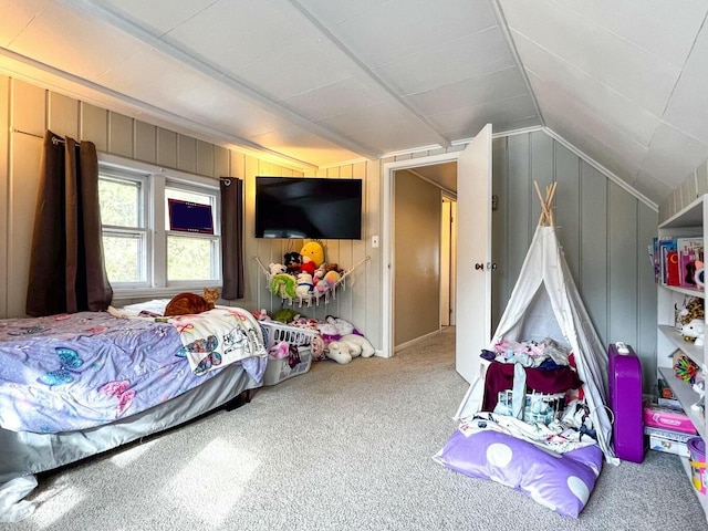 bedroom featuring lofted ceiling, carpet flooring, and wood walls