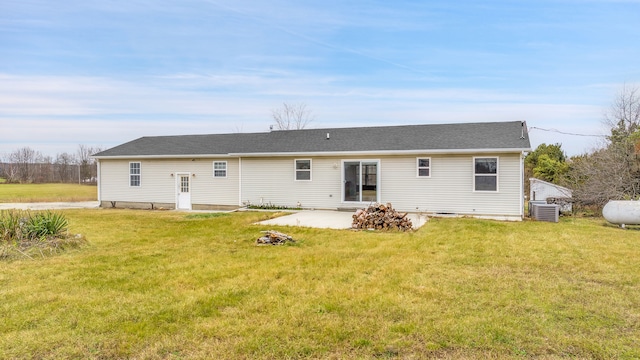 back of house featuring a lawn, central air condition unit, and a patio area