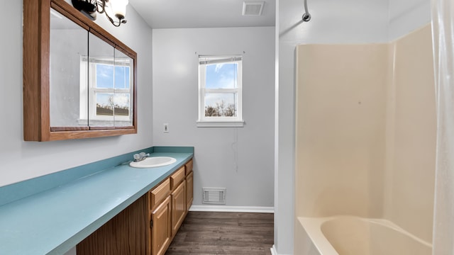 bathroom featuring vanity, hardwood / wood-style flooring, and shower / bathtub combination