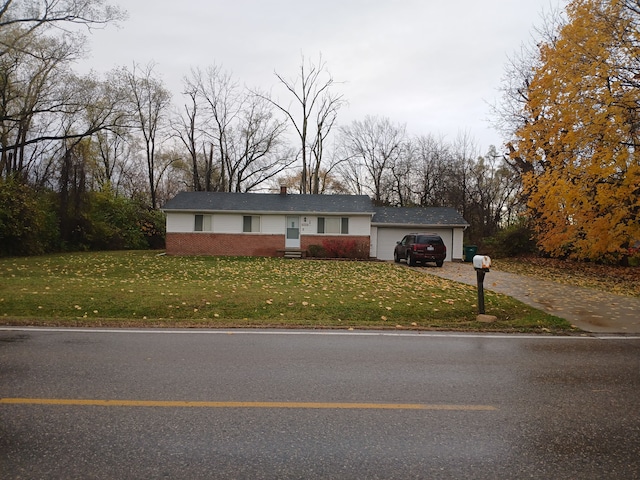 single story home with a garage and a front lawn