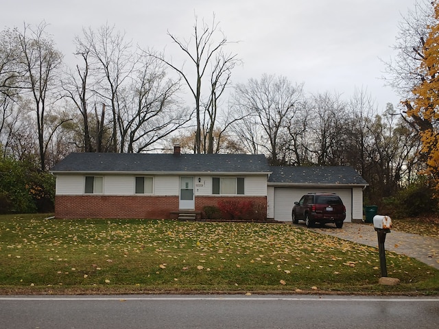 single story home with a garage and a front lawn