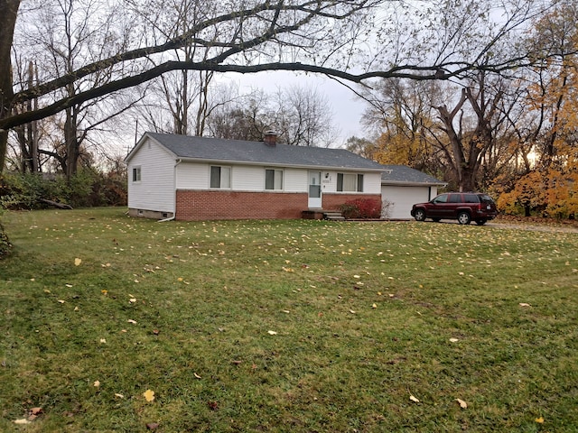 ranch-style house with a garage and a front lawn