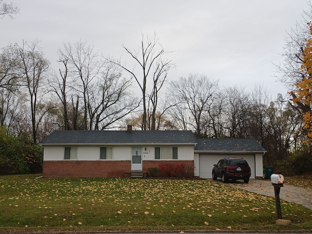 ranch-style house featuring a garage and a front yard