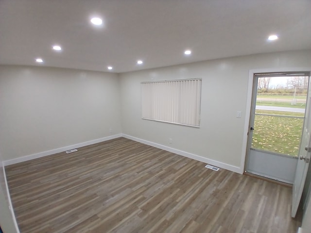 unfurnished room with wood-type flooring