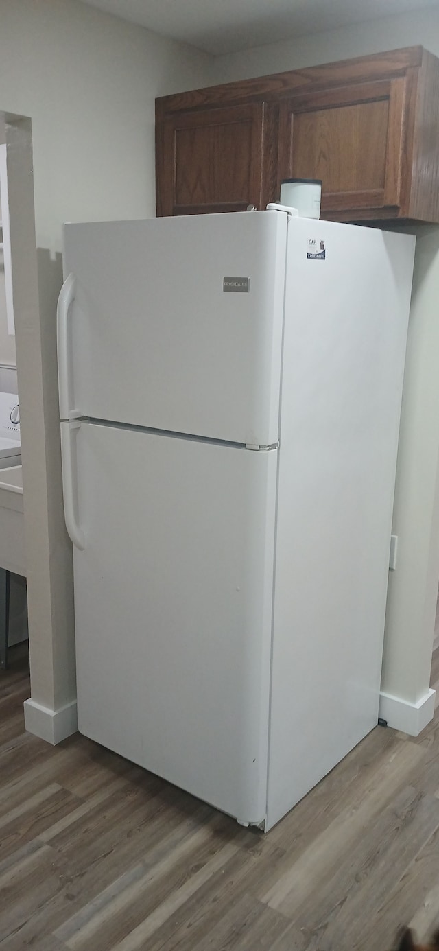 kitchen with white refrigerator and light wood-type flooring