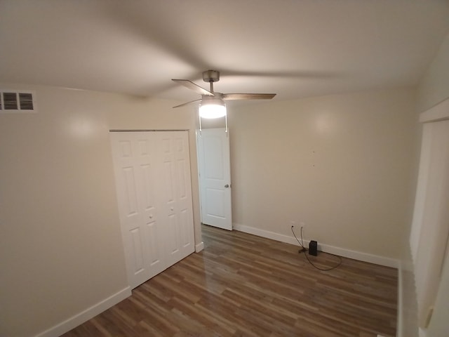 clothes washing area featuring dark wood-type flooring and ceiling fan