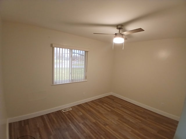 unfurnished room with dark hardwood / wood-style flooring and ceiling fan