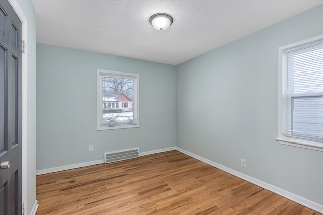 spare room with light hardwood / wood-style flooring