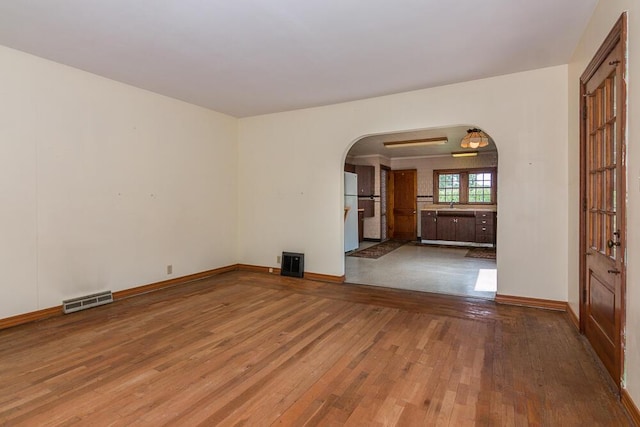 unfurnished room with wood-type flooring