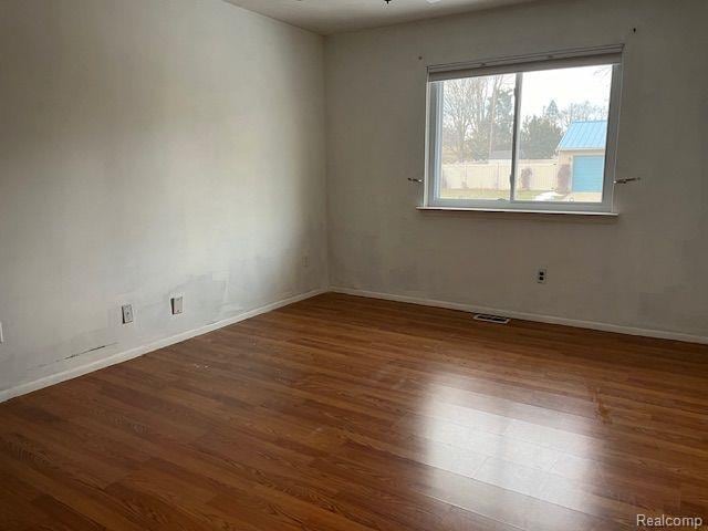 392 Hillcrest Dr, Saline, MI 48176 - unfurnished room featuring wood finished floors and baseboards