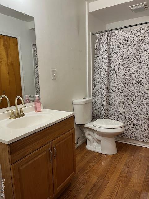 392 Hillcrest Dr, Saline, MI 48176 - bathroom featuring vanity, wood finished floors, and curtained shower