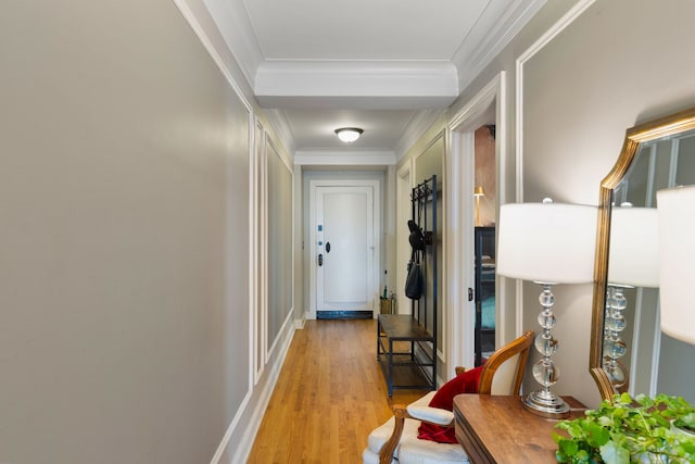 hallway with crown molding and light wood-type flooring