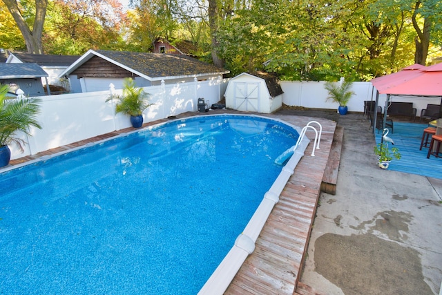 view of swimming pool with a storage shed, a gazebo, and a deck