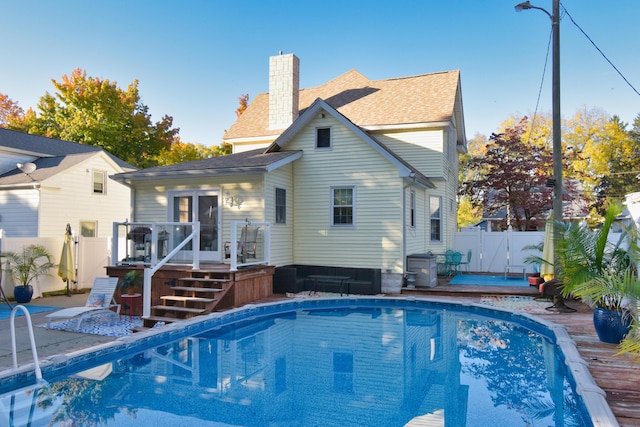 back of house with a pool side deck