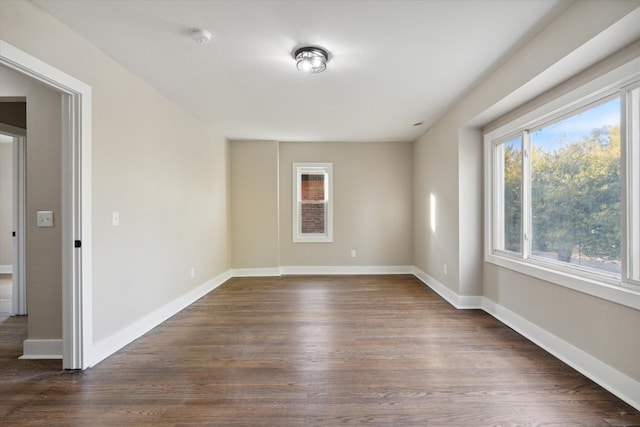 unfurnished room featuring dark wood-type flooring