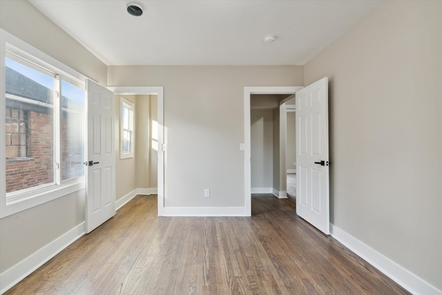 unfurnished bedroom with wood-type flooring