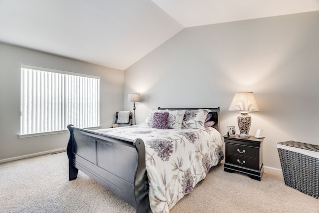 carpeted bedroom with vaulted ceiling