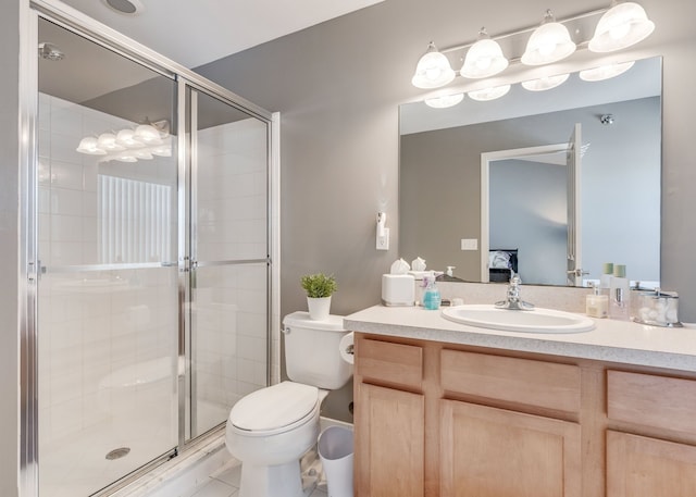 bathroom with vanity, a shower with shower door, and toilet