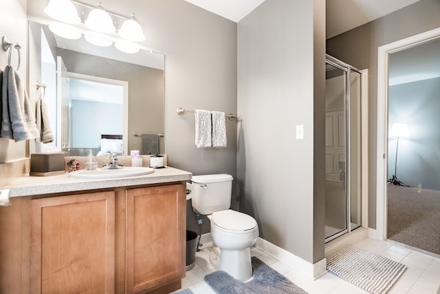 bathroom with tile patterned floors, vanity, toilet, and an enclosed shower