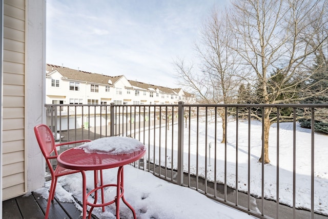 view of snow covered back of property