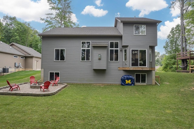 back of property with a patio area, central AC, a lawn, and an outdoor fire pit